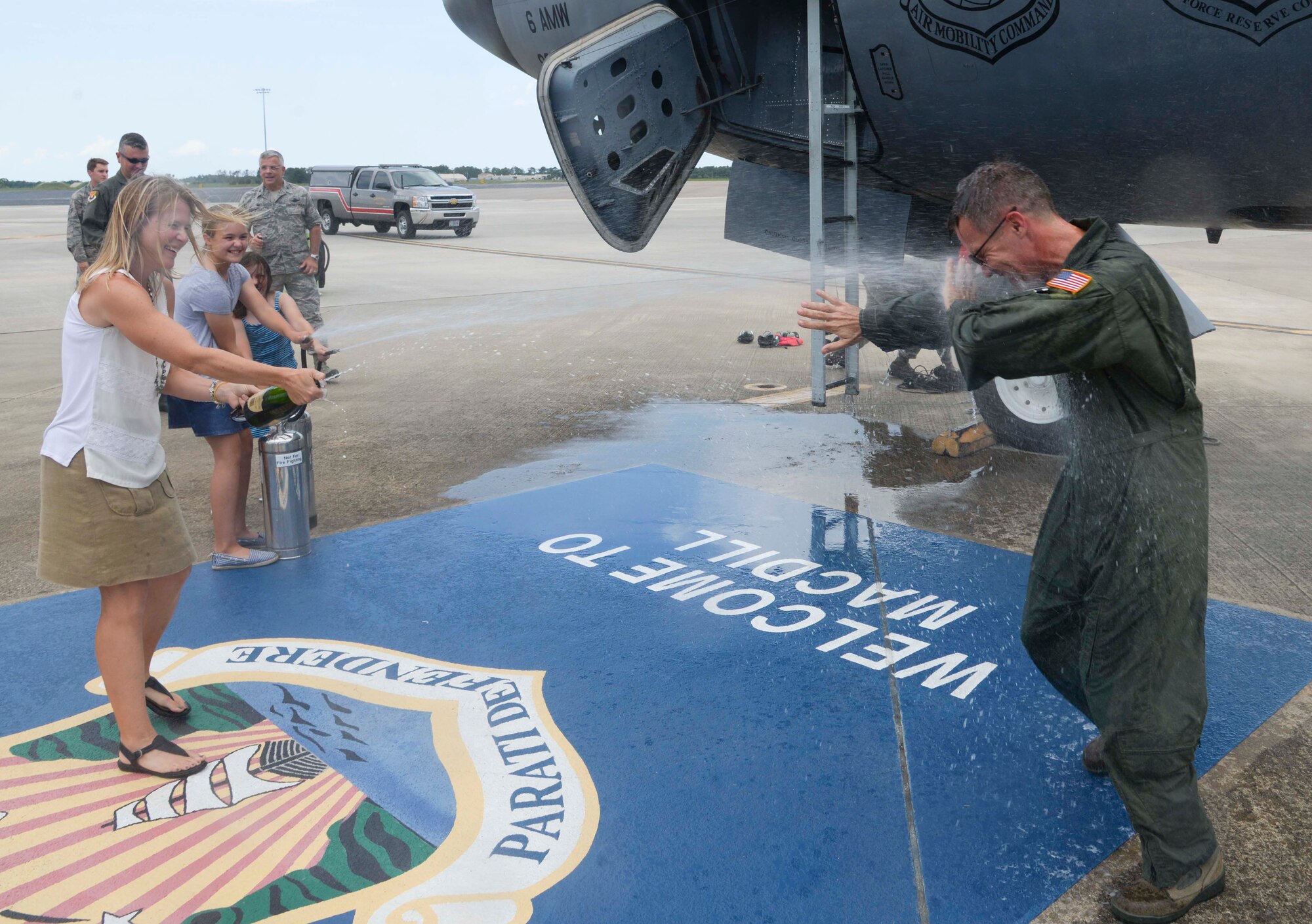 Col. Daniel Tulley, right, commander of the 6th Air Mobility Wing, is sprayed with water and champagne by his family during his fini flight at MacDill Air Force Base, Fla., June 28, 2016. Tulley’s two-year tenure comes to an end as he prepares to relinquish command on July 8. 