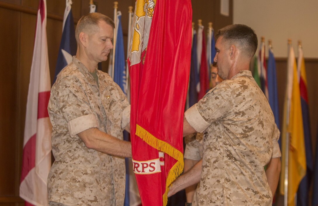 Col. Steven G. Godinho (right), the former commanding officer of Headquarters Battalion, Marine Forces Reserve, passes the colors to Col. Derrick R. Heyl (left), the new commanding officer of Headquarters Battalion, during a change of command ceremony at Marine Corps Support Facility New Orleans, July 1, 2016. Before assuming this position, Heyl served as the Assistant Chief of Staff G-3 with Headquarters 4th Marine Aircraft Wing, MARFORRES.  (U.S. Marine Corps photo by Sgt. Ian Leones/Released)