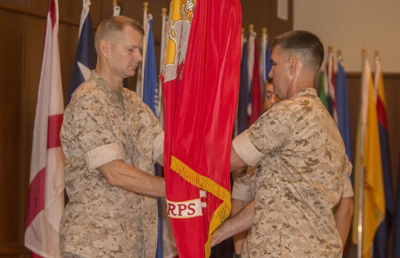 Col. Steven G. Godinho (right), the former commanding officer of Headquarters Battalion, Marine Forces Reserve, passes the colors to Col. Derrick R. Heyl (left), the new commanding officer of Headquarters Battalion, during a change of command ceremony at Marine Corps Support Facility New Orleans, July 1, 2016. Before assuming this position, Heyl served as the Assistant Chief of Staff G-3 with Headquarters 4th Marine Aircraft Wing, MARFORRES.  (U.S. Marine Corps photo by Sgt. Ian Leones/Released)