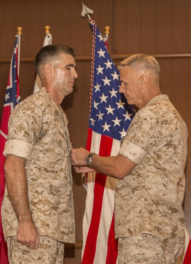 Lt. Gen. Rex C. McMillian, commander of Marine Forces Reserve and Marine Forces North, awards Col. Steven G. Godinho, commanding officer of Headquarters Battalion, MARFORRES, the Legion of Merit for his service to Headquarters Battalion during a change of command ceremony at Marine Corps Support Facility New Orleans, July 1, 2016. Godinho assumed command of Headquarters Battalion in June 2014 and will retire from the Marine Corps after 24 years of faithful service. (U.S. Marine Corps photo by Sgt. Ian Leones/Released)