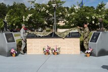 U.S. Air Force Maj. Gen. Anthony German, New York Air National commander, and Col. Michael Ross, 820th Base Defense Group commander, unveil a monument during a memorial service, June 30, 2016, at Moody Air Force Base, Ga. The monument is dedicated to Tech. Sgt. Joseph G. Lemm and Staff Sgt. Louis M. Bonacasa, and decorated with plaques that symbolize their sacrifices and tell their stories. (U.S. Air Force photo by Airman 1st Class Janiqua P. Robinson/Released)