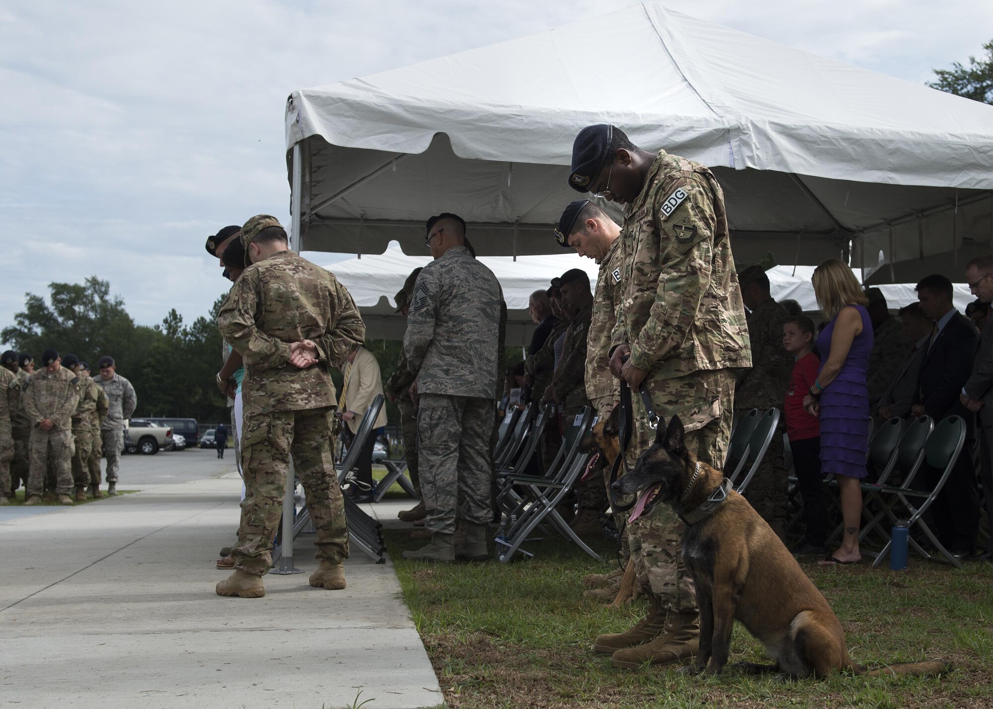 U.S. Air Force Airmen bow their heads in prayer during a memorial service, June 30, 2016, at Moody Air Force Base, Ga. Airmen from the Air Force Office of Special Investigations, 820th Base Defense Group, and the 105th Base Defense Squadron, gathered in remembrance of Tech. Sgt. Joseph G. Lemm and Staff Sgt. Louis M. Bonacasa. (U.S. Air Force photo by Airman 1st Class Janiqua P. Robinson/Released)
