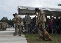 U.S. Air Force Airmen bow their heads in prayer during a memorial service, June 30, 2016, at Moody Air Force Base, Ga. Airmen from the Air Force Office of Special Investigations, 820th Base Defense Group, and the 105th Base Defense Squadron, gathered in remembrance of Tech. Sgt. Joseph G. Lemm and Staff Sgt. Louis M. Bonacasa. (U.S. Air Force photo by Airman 1st Class Janiqua P. Robinson/Released)