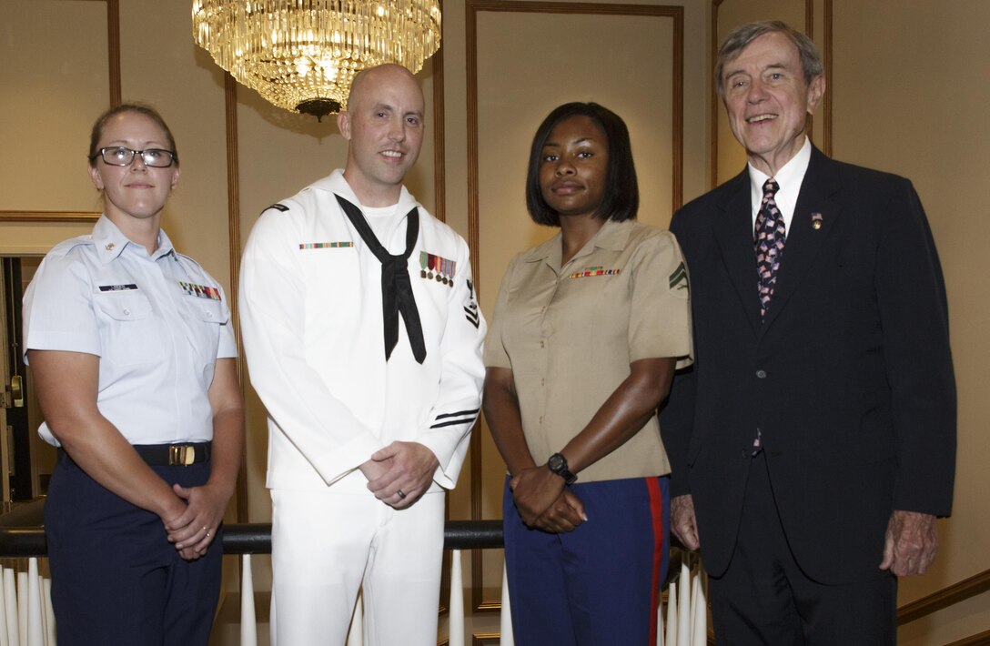 Service members from units in the New Orleans area pose for a picture with Tommy Lind, the president of the Navy League of the United States Greater New Orleans Council, at “A Taste’n Toast to Our Armed Services” event at the Bourbon Orleans Hotel, New Orleans, July 30, 2016. The Service members were recognized as the Sailor, Marine and Coast Guardsman of the Year for their respective units. The Navy League is comprised of 40,000 civilians in more than 240 councils around the world working to support sea service members and their families. (U.S. Marine Corps photo by Sgt. Ian Leones/Released)