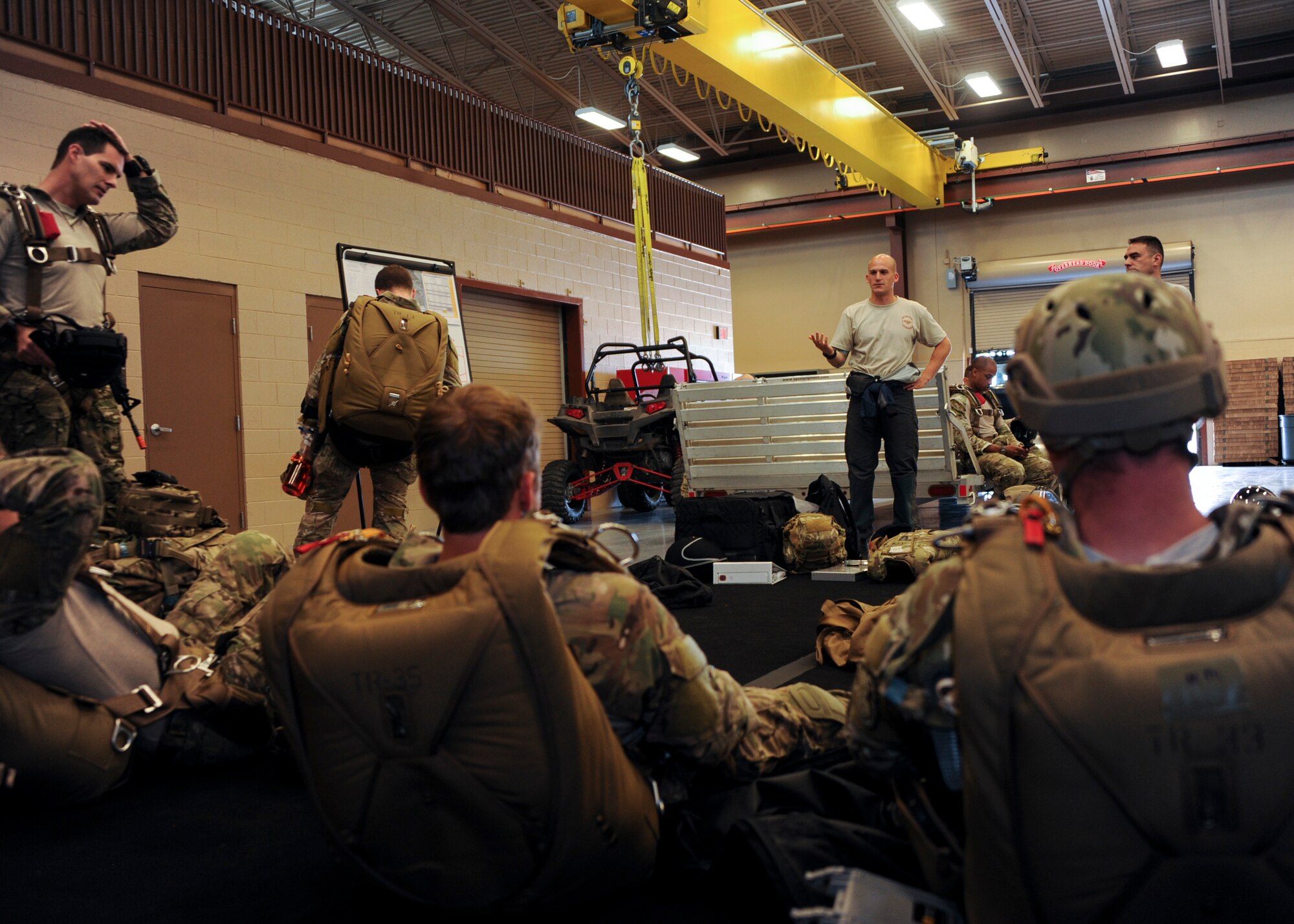 U.S. Airmen receive instructions during the Military Freefall Jumpmaster Course at Davis-Monthan Air Force Base, Ariz., June 28, 2016. The course will graduate 12 Airmen at the end of its fifth 3-week-long rotation; reaching a total number of 58 certified jumpmasters. (U.S. Air Force photo by Airman Nathan H. Barbour/Released)