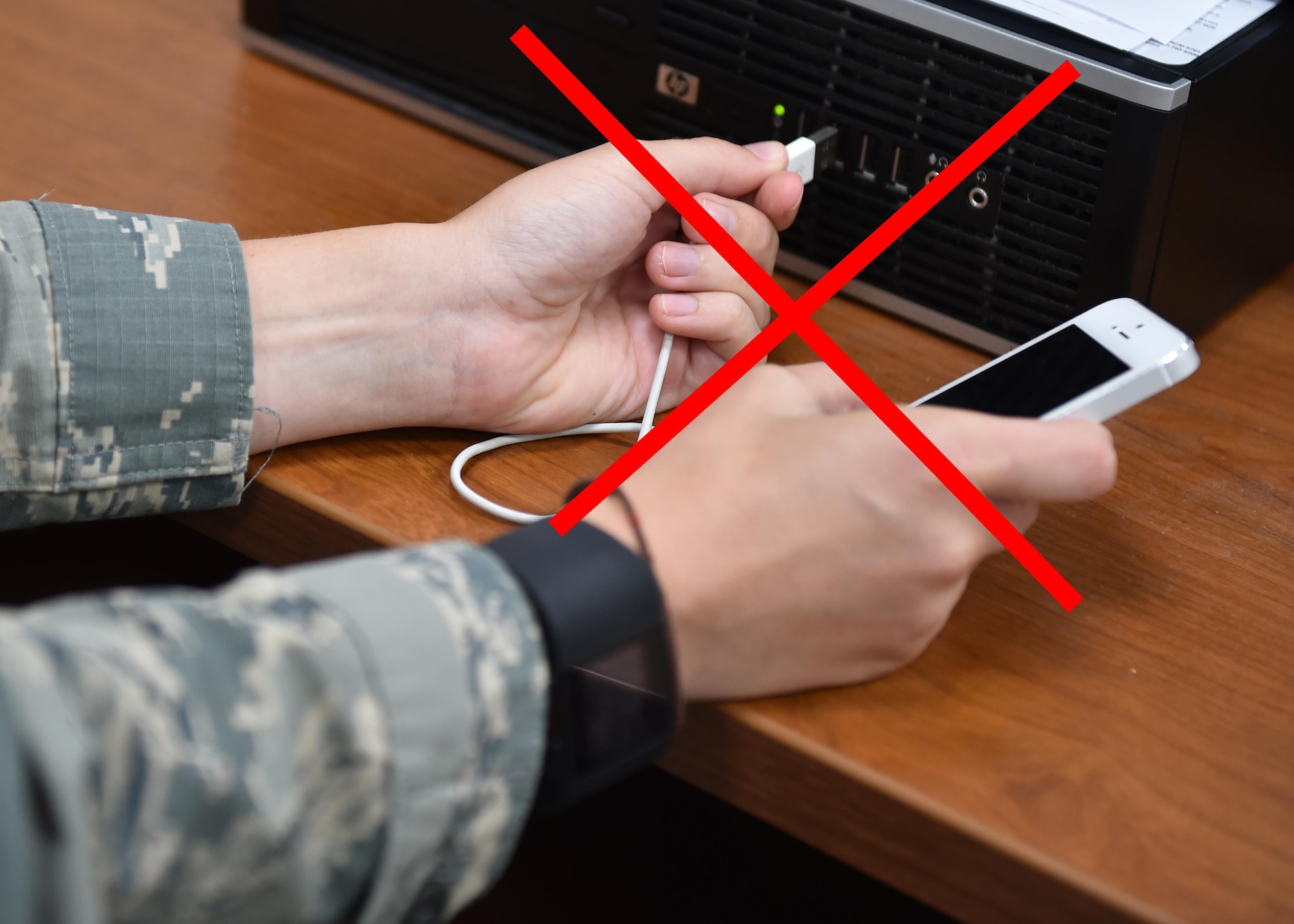 A photo illustration reminds Airmen not to plug unauthorized devices into government computers. (U.S. Air Force illustration/Tech. Sgt. James Brock)