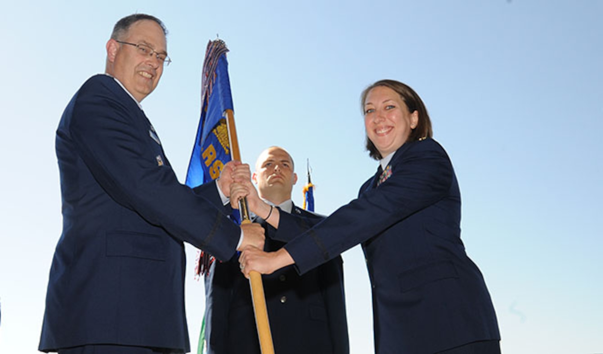 Maj. Kelly Smith, right, the new commander of the 92nd Logistics Readiness Squadron, takes the 92nd LRS guidon from Col. David Stookey, the 92nd Mission Support Group commander, during the 92nd LRS change of command ceremony June 30, 2016, at Fairchild Air Force Base, Wash. Smith assumed command from Maj. Lance Vann, who leaves Team Fairchild for the 735th Air Mobility Squadron at Joint Base Pearl Harbor-Hickam, Hawaii. The change of command ceremony is a tradition meant to represent the shift of responsibility for a unit from one officer to another. (U.S. Air Force photo/Senior Airman Sam Fogleman)