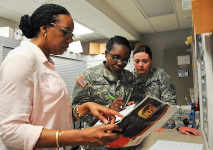 Angela Payne, official mail manager for the U.S. Army Reserve’s 99th Regional Support Command (left), works with Soldiers from the U.S. Army Reserve’s 678th Human Resources Company headquartered in Nashville, Tennessee, at 99th RSC headquarters on Joint Base McGuire-Dix-Lakehurst, New Jersey. This training kicked off 163 mailroom inspections conducted by the 678th over a two-week period at Army Reserve facilities throughout the northeastern United States as part of a pilot program hosted by the 99th RSC in order to provide real-world training opportunities to boost Soldier readiness.