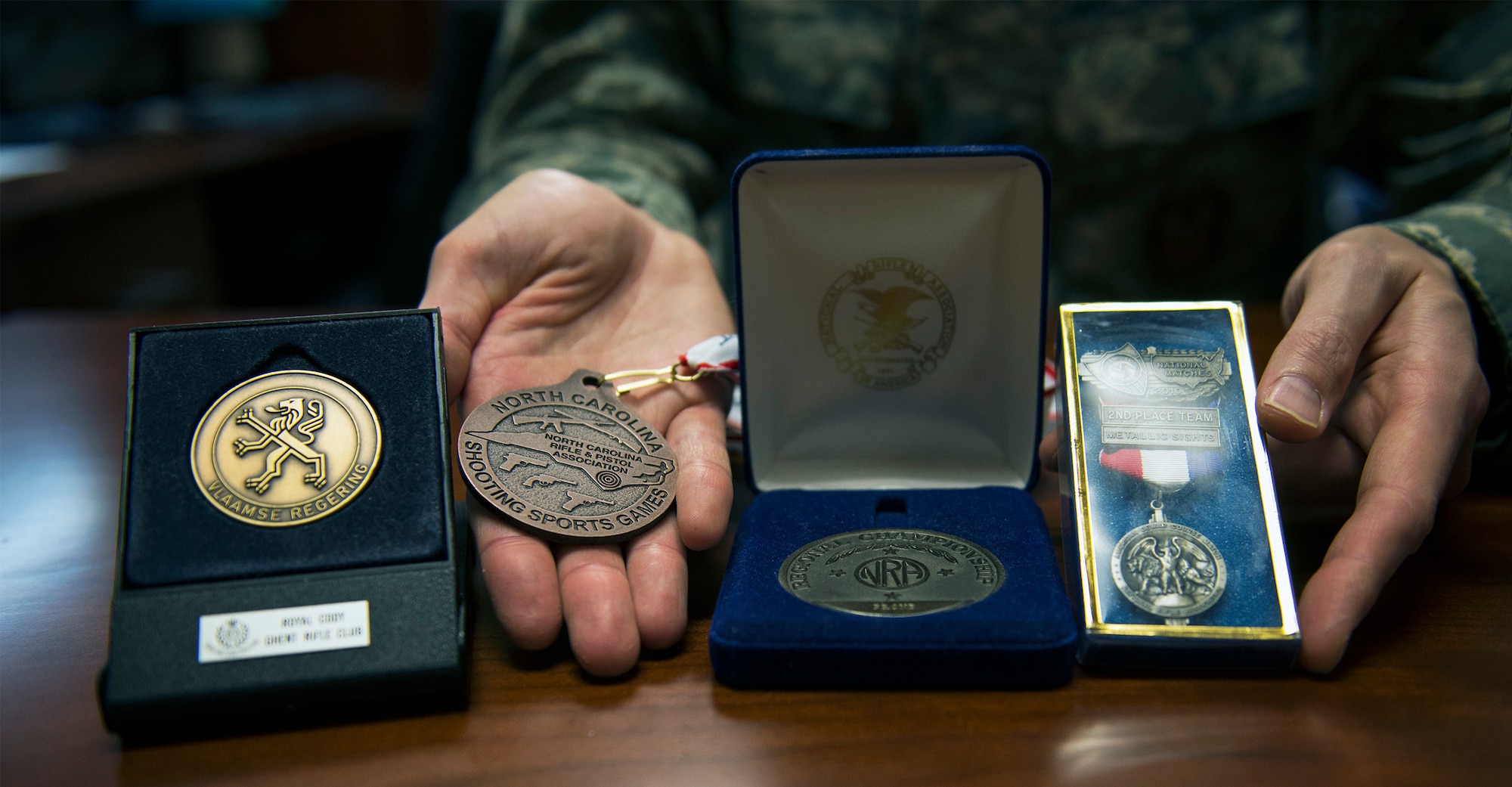 U.S. Air Force Maj. Robert Davis, 93d Air Ground Operations Wing director of complaints resolution, poses with his competitive shooting awards and medals July 1, 2016, at Moody Air Force Base, Ga. He considers winning the 2005 Master of Flanders his most prestigious accomplishment in which he became the first American to garner first place honors in the Belgian competitive shooting series. (U.S. Air Force photo by Airman 1st Class Greg Nash/Released) 