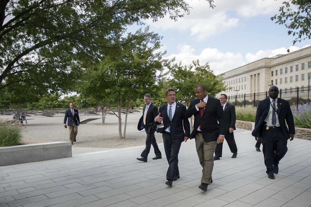 Defense Secretary Ash Carter speaks with Transportation Secretary Anthony Foxx as he gives him a tour of the Pentagon Memorial, July 1, 2016. DoD photo by Air Force Senior Master Sgt. Adrian Cadiz