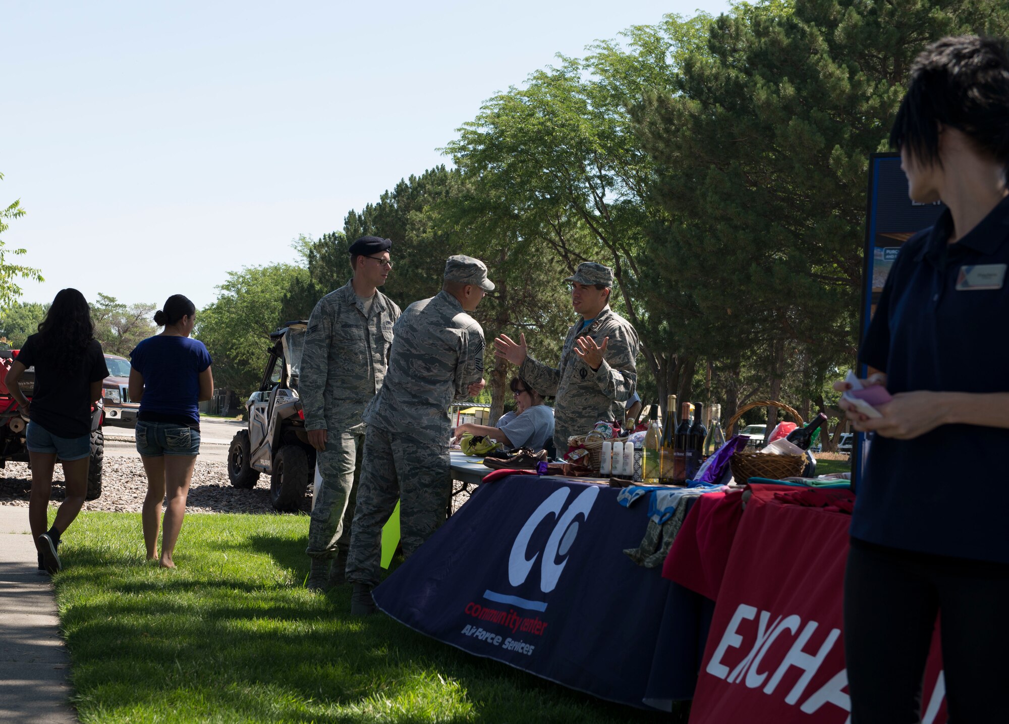 Maj. Thaddeus Speed, 366th Medical Squadron Bio Flight Commander, talks to individuals interested in the Mountain Home Air Force Base Running Club during the 366th Force Support Squadron summer social and Gunfighter Theater re-opening July 1, 2016, at Mountain Home Air Force Base, Idaho. The summer social consisted of bouncy houses, prizes, food and the introduction of the new social club programs. (U.S. Air Force photo by Airman 1st Class Chester Mientkiewicz/Released)