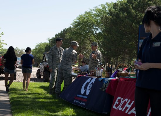 Maj. Thaddeus Speed, 366th Medical Squadron Bio Flight Commander, talks to individuals interested in the Mountain Home Air Force Base Running Club during the 366th Force Support Squadron summer social and Gunfighter Theater re-opening July 1, 2016, at Mountain Home Air Force Base, Idaho. The summer social consisted of bouncy houses, prizes, food and the introduction of the new social club programs. (U.S. Air Force photo by Airman 1st Class Chester Mientkiewicz/Released)