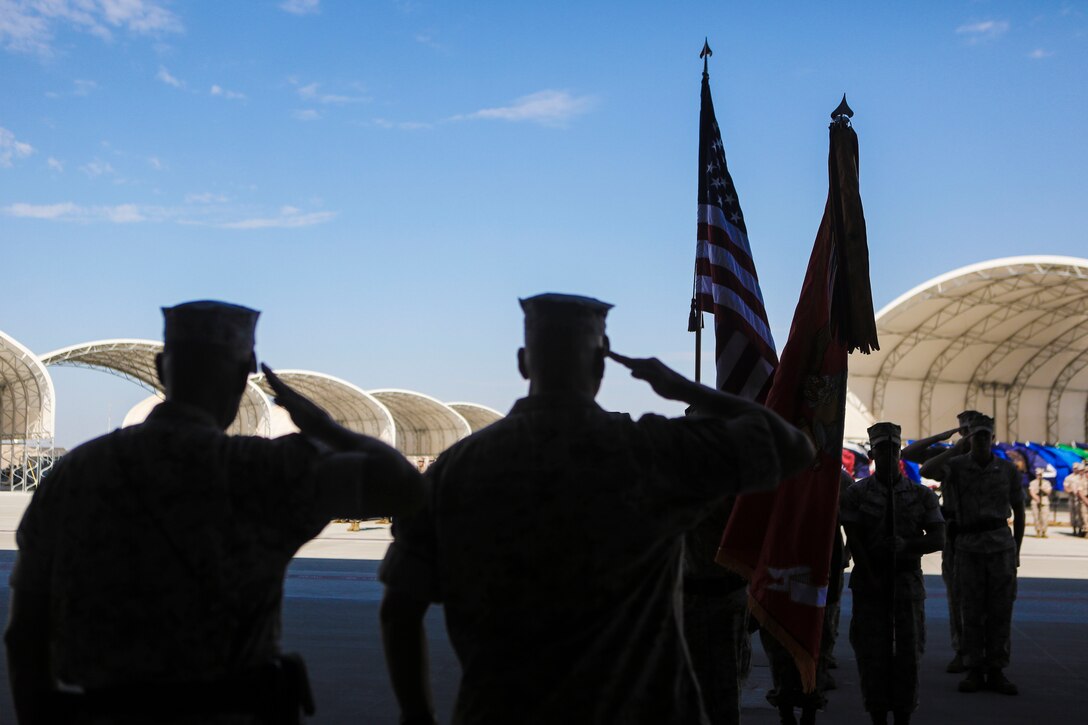 Sgt. Maj. Allen Goodyear, sergeant major of Marine Fighter Attack Squadron (VMFA) 211, and Col. Marcus Annibale, commanding officer of Marine Aircraft Group (MAG) 13, salute the colors during a re-designation and change of command ceremony aboard Marine Corps Air Station Yuma, Ariz., June 30. During the ceremony, Marine Attack Squadron (VMA) 211 transitioned to VMFA-211 making it the first AV-8B Harrier squadron to become an F-35B Lightning II Joint Strike Fighter squadron. (U.S. Marine Corps photo by Lance Cpl. Harley Robinson/Released.)
