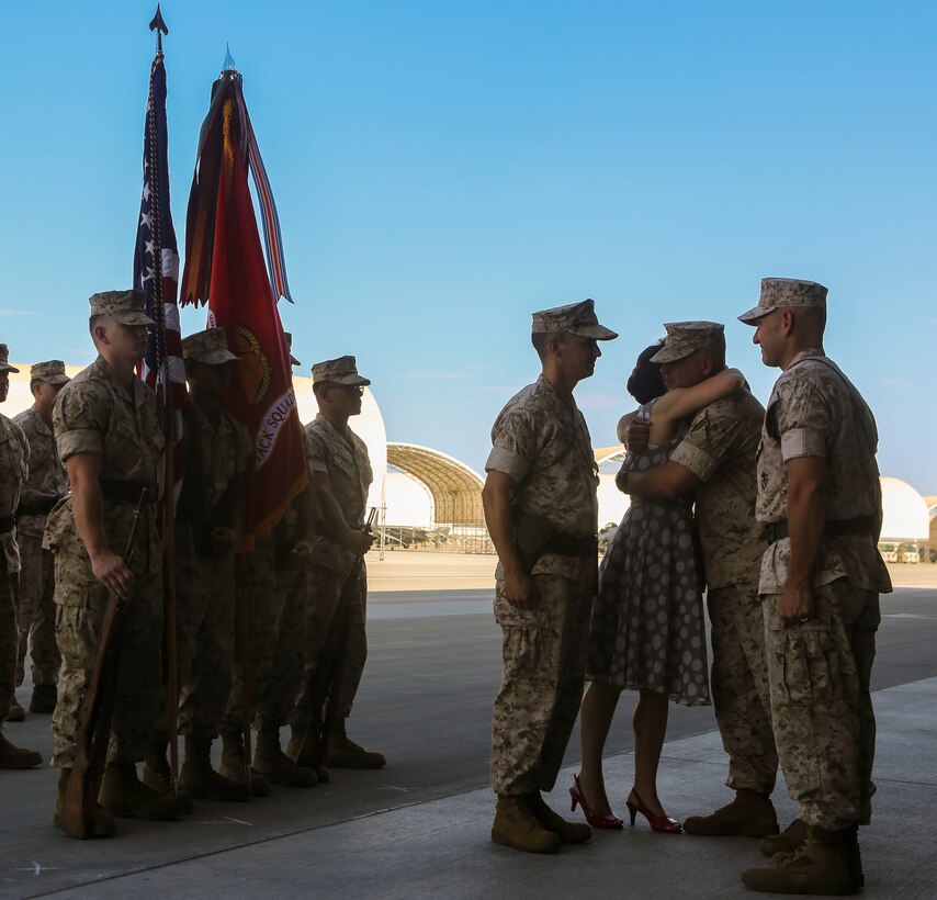 Lt. Col. William Maples’ wife is congratulated after receiving a certificate of appreciation during a re-designation and change of command ceremony aboard Marine Corps Air Station Yuma, Ariz., June 30. During the ceremony, Marine Attack Squadron (VMA) 211 transitioned to Marine Fighter Attack Squadron (VMFA) 211 making it the first AV-8B Harrier squadron to become an F-35B Lightning II Joint Strike Fighter squadron. (U.S. Marine Corps photo by Lance Cpl. Harley Robinson/Released.)