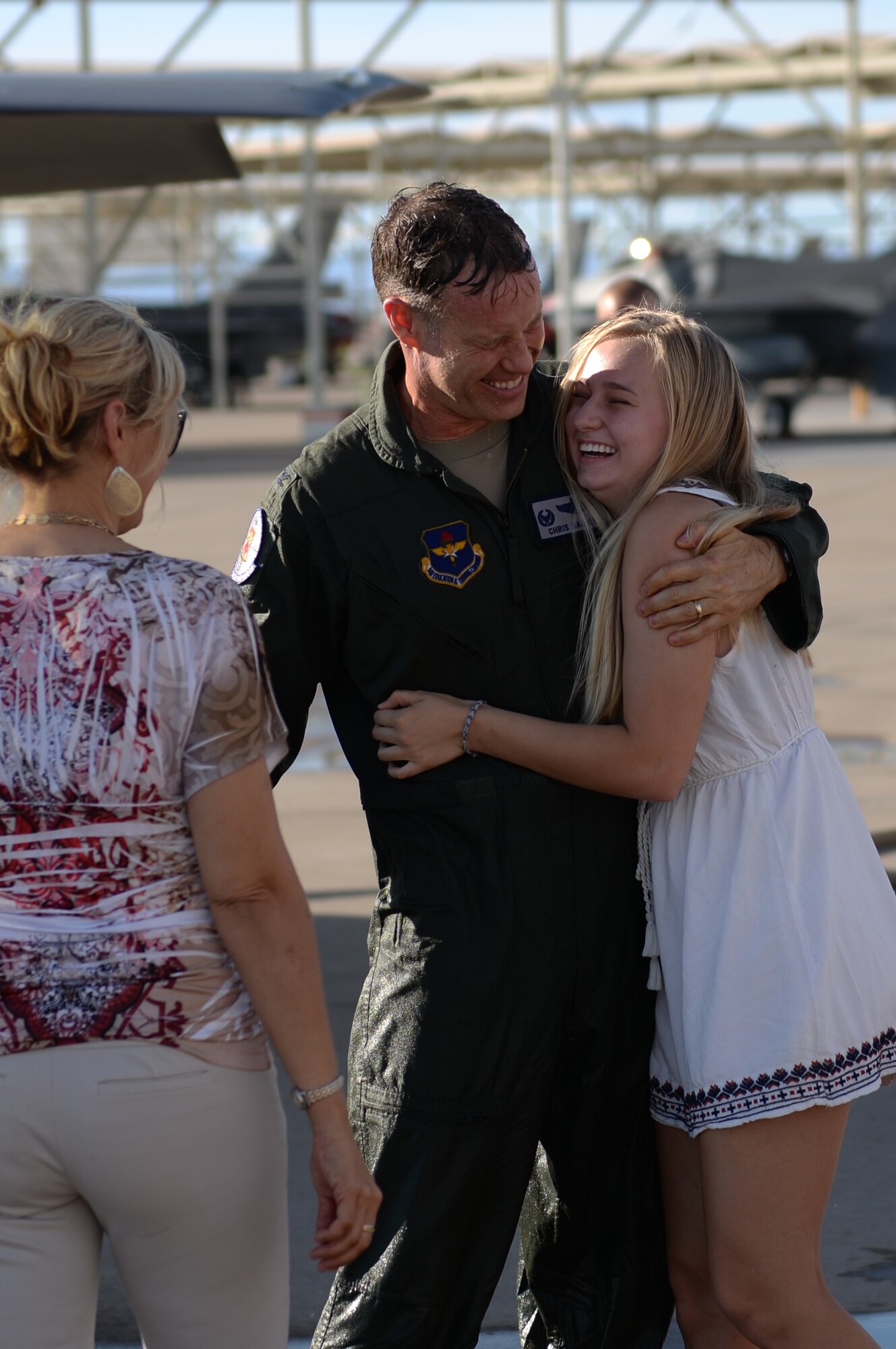 Col. Chris Bailey, 56th Operations Group commander, receives a hug from his daughter after his final flight in an F-35 Lightning II June 30, 2016. His two-year tenure as commander was filled with change as the wing shifted its mission to include the F-35. (U.S. Air Force photo by Airman 1st Class Ridge Shan)