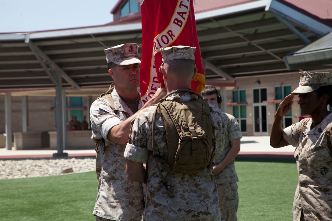 U.S. Marine Corps Lt. Col. Brian Dwyer, right, outgoing commanding officer, Wounded Warrior Battalion-West, relinquishes command to Lt. Col. Stephen Mount, left, commanding officer, WWBN-W, during a Change of Command Ceremony at Camp Pendleton, Calif., June 30, 2016.  A Change of Command is a military tradition that represents a formal transfer of authority and responsibility for a unit from one Commanding Officer to another. (U.S. Marine Corps photo by Lance Cpl. Brandon Martinez, MCIWEST-MCB CamPen Combat Camera/Released)