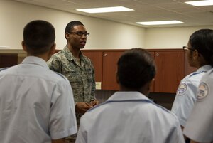 U.S. Air Force Airman 1st Class Pierre Armstrong, 633rd Force Support Squadron career development apprentice, briefs Air Force Junior ROTC cadets about the FSS, during a shadow day at Langley Air Force Base, Va., June 29, 2016. About 70 cadets from four local high schools paired with 10 Airmen to learn about the Air Force mission during a weeklong summer leadership program. (U.S. Air Force photo by Airman 1st Class Kaylee Dubois)