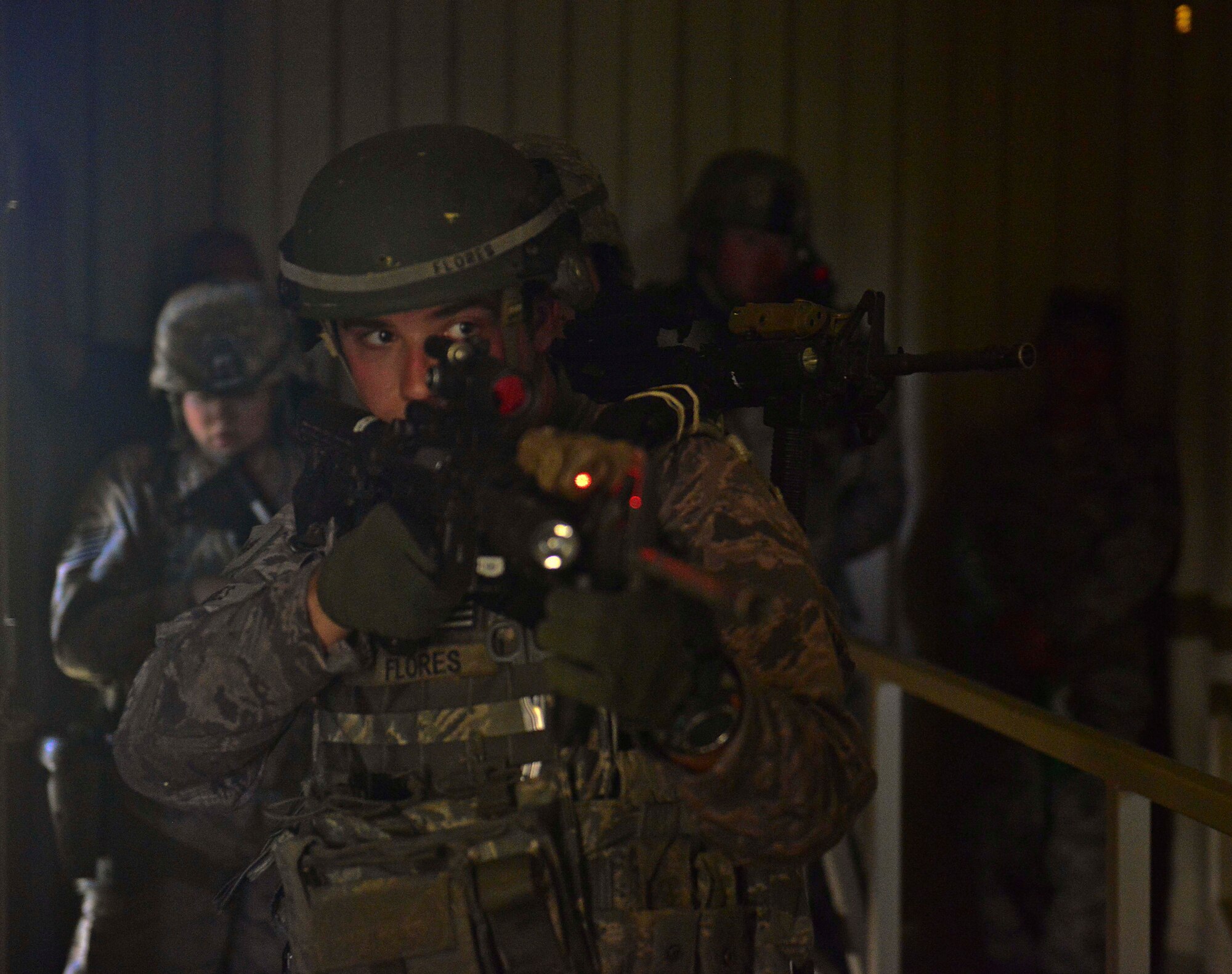 U.S. Air Force Staff Sgt. Corie Flores, 633rd Security Forces Squadron, Base Defense Operations Center operator and squad clear a mock control tower building during Combat Readiness Training at Langley Air Force Base, Va., June 27, 2016.  Base security operations is one of eight blocks of instruction taught at CRT.  (U.S. Air Force photo by/Tech. Sgt. Daylena S. Ricks)