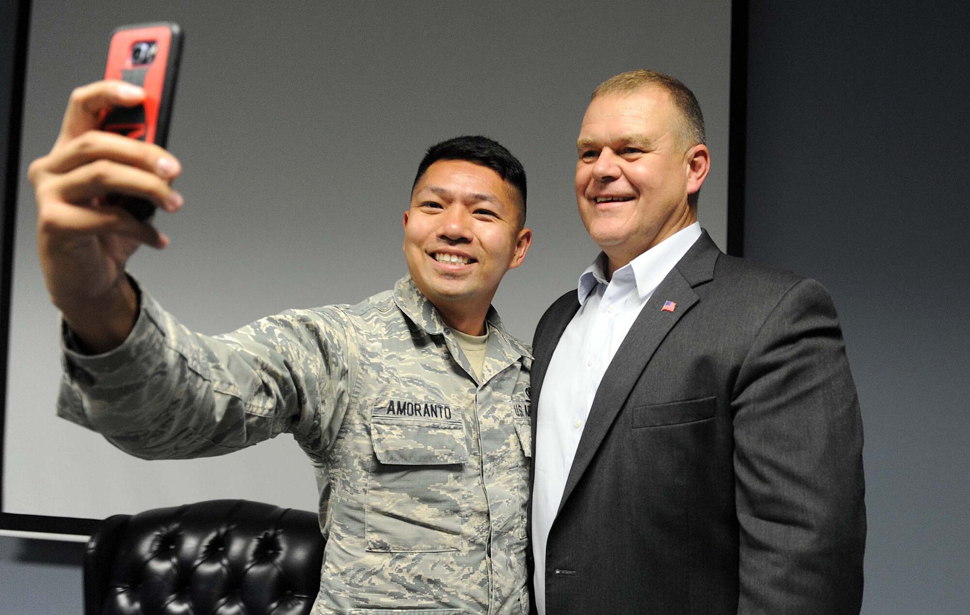 Senior Airman Kristian-Alan Amoranto, 78th Security Forces Squadron combat arms instructor, takes a selfie with retired Chief Master Sgt. of the Air Force James Roy during his recent visit to Robins. Roy, who served as the 16th Chief Master Sergeant of the Air Force, spoke to local Airman Leadership School students, June 27, 2016 prior to their graduation June 28. (U.S. Air Force photo by Tommie Horton)