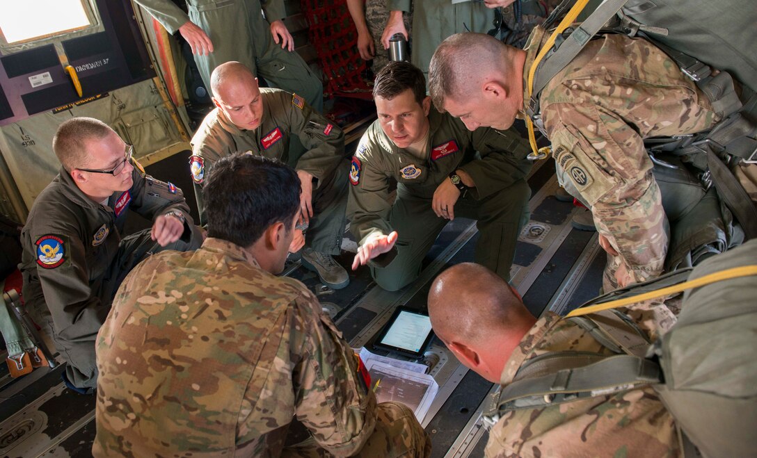 U.S. Air Force Airmen assigned to the 39th Airlift Squadron and 9th Bomb Squadron brief U.S. Army 82nd Airborne Division Soldiers before a flight during a Joint Forcible Entry Exercise June 18, 2016, at Dyess Air Force Base, Texas. Dyess C-130Js carried the soldiers over the Nevada Test and Training Range to perform airdrops and tactically deploy and recover ground troops. (U.S. Air Force photo by Airman 1st Class Austin Mayfield/ Released)