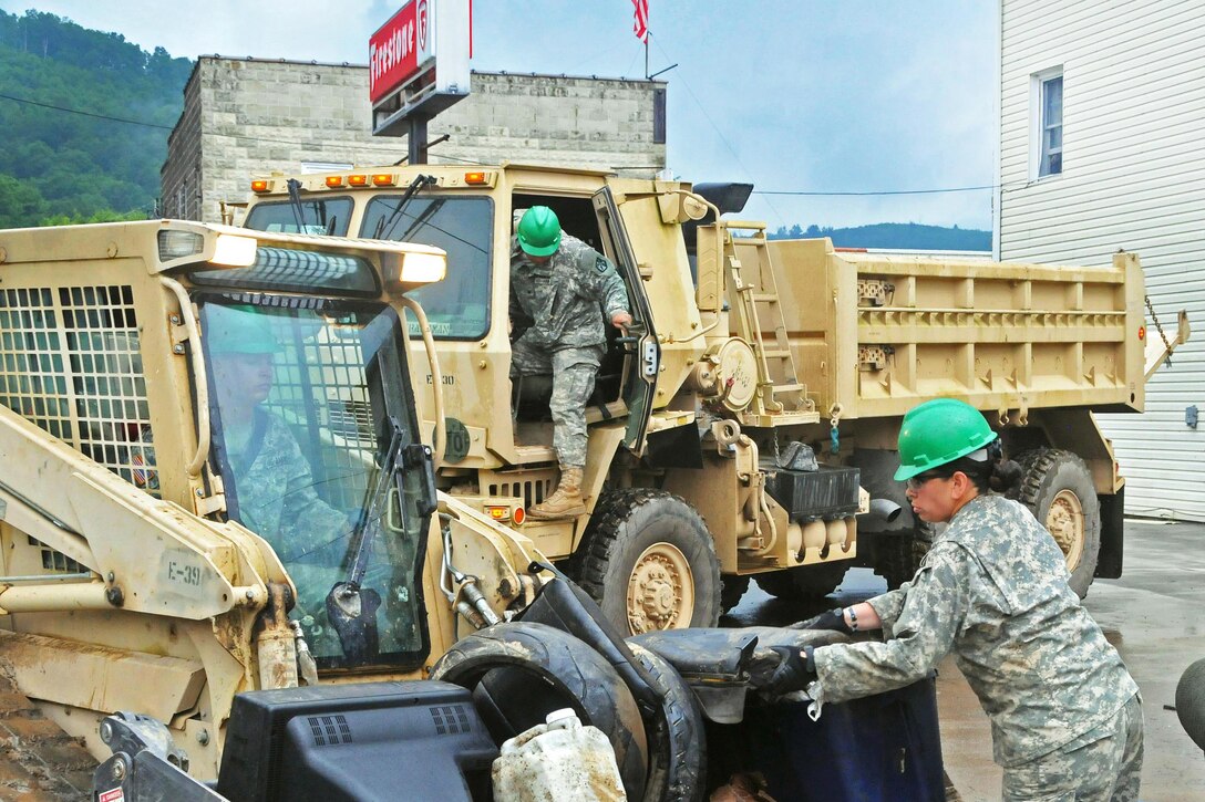 Soldiers help remove debris after historic flooding in Rainelle, W.Va., June 27, 2016. The soldiers are assigned to the Rhode Island Army National Guard's 861st Engineer Company. Army National Guard photo by Staff Sgt. Justin Hough

