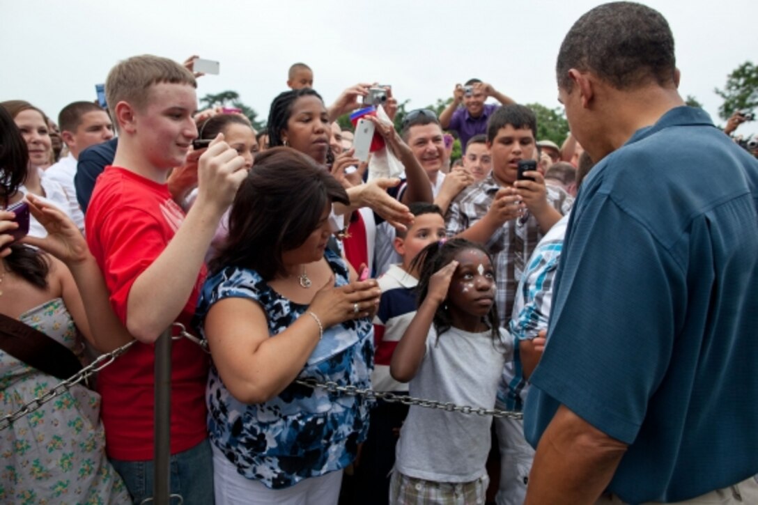 A young girl snaps a salute for President Barack Obama as he greets members of the military and their families on the White House’s South Lawn on Independence Day, July 4, 2011. In his weekly address issued July 2, 2016, President Barack Obama noted that he, First Lady Michelle Obama, and their two daughters will be hosting hundreds of service members, military veterans and their families at the traditional White House cookout on Independence Day, July 4, 2016. Official White House photo by Pete Souza
