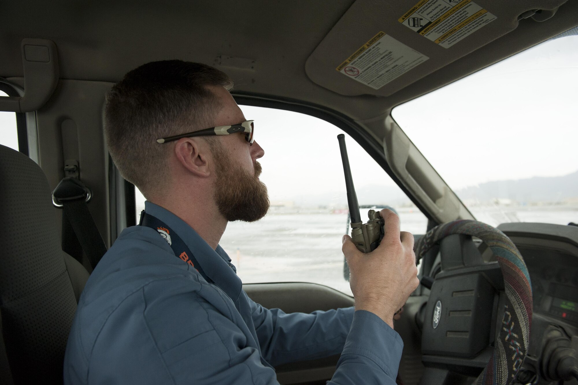 Mr. Ben Allen, U.S. Department of Agriculture Wildlife Services wildlife specialist and biologist, radios in to Bagram Airfield ground control prior to entering the runway, June 30, 2016, Bagram Airfield, Afghanistan. Allen works directly with the 455th Air Expeditionary Wing Safety Office to provide his expertise on wildlife management. (U.S. Air Force photo by Capt. Korey Fratini) 