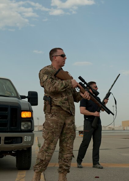 Lt. Col. James Cooper (front), 455th Air Expeditionary Wing chief of safety and Mr. Ben Allen (back), U.S. Department of Agriculture Wildlife Services wildlife specialist and biologist, prepare to fire an air powered pellet rifle and shot gun, June 30, 2016, Bagram Airfield, Afghanistan. The 455th AEW Safety office and the USDA use wildlife depredation tactics as just one of the many tools in order to effectively mitigate the impact of birds and wildlife on safe air operations. (U.S. Air Force photo by Capt. Korey Fratini)