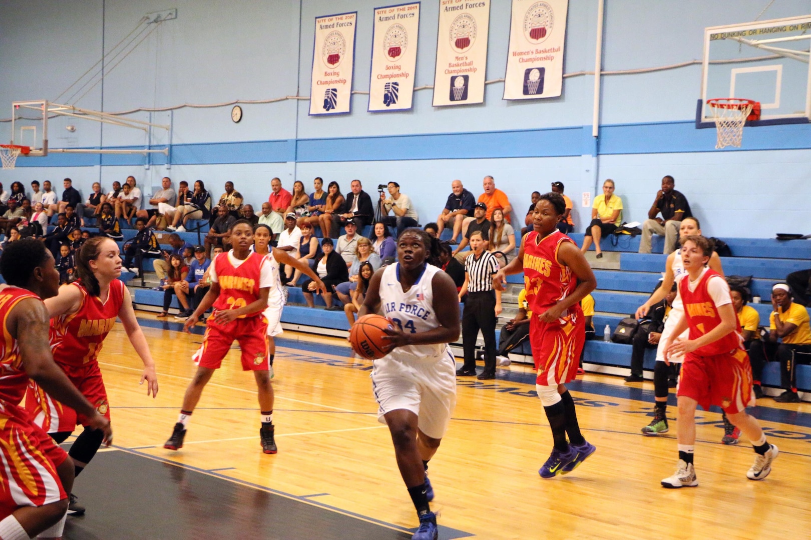 Airman Staff Sgt. Charnaine Clark (#34) drives the land as Air Force defeats Marine Corps 95-51 in the opening game of the 2016 Armed Forces Women's Basketball Championship at Joint Base San Antonio-Lackland AFB, Texas on 1 July.  