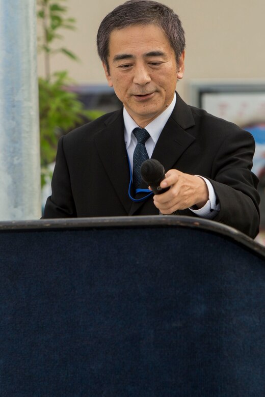 Kiyotaka Nozaki, Chugoku-Shikoku Defense Bureau deputy procurement director, addresses the audience during the grand opening of the Command Assembly Hall at Marine Corps Air Station Iwakuni, Japan, July 1, 2016. Costing approximately $28 million, construction of the building began September 2013 and finished March 2016 with an additional $1.5 million spent furnishing the facility. Located behind the new commissary between Club Iwakuni and the Kawashimo housing area, the new building replaces the Sakura Theater. (U.S. Marine Corps photo by Lance Cpl. Aaron Henson/Released)
