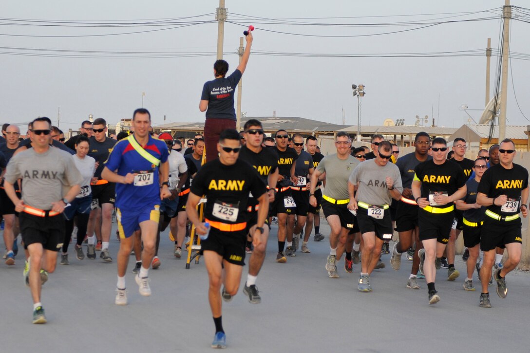 U.S. service members, along with coalition troops from Romania, Bulgaria, Australia and Poland, kick off the Fourth of July with a fun run through Kandahar Airfield in Afghanistan, July 4, 2016. Air Force photo by Maj. Luke Talbot