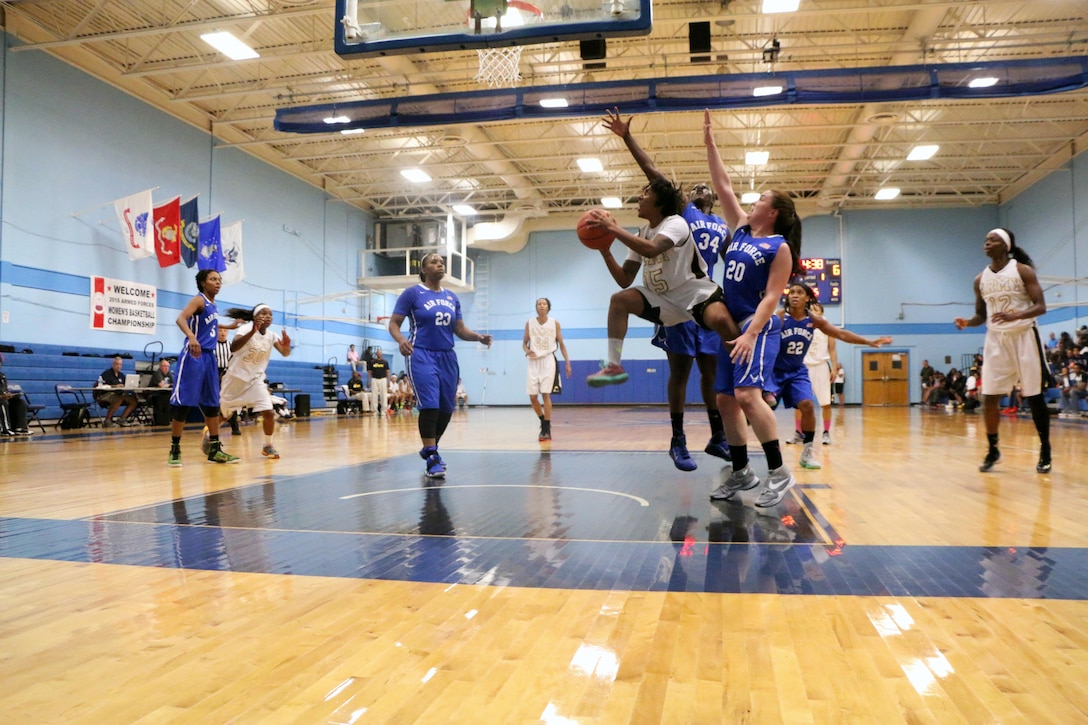 Army Spc. Danielle Deberry (#15) of Fort Bragg, N.C. drives the lane over Air Force defendersduring the 2016 Armed Forces Women's Basketball Championship at Joint Base San Antonio-Lackland AFB, Texas on 3 July.  Army would win the contest 70-55.