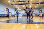 Army Spc. Danielle Deberry (#15) of Fort Bragg, N.C. drives the lane over Air Force defendersduring the 2016 Armed Forces Women's Basketball Championship at Joint Base San Antonio-Lackland AFB, Texas on 3 July.  Army would win the contest 70-55.