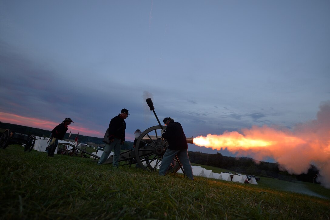 Reenactors with the 6th New York Light Artillery fire a Civil War-era cannon at dusk during the 153rd anniversary of the Battle of Gettysburg in Gettysburg, Pa., July 2, 2016. The reenactors included veterans from the Army, Navy, Marines and Army National Guard.  Air National Guard photo by Staff Sgt. Christopher S. Muncy

