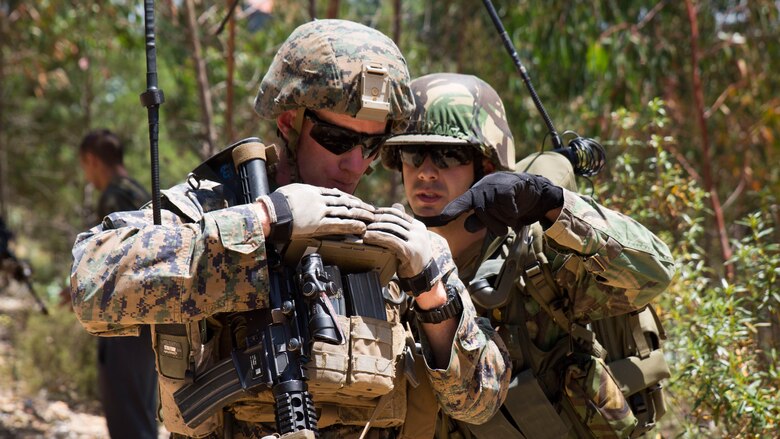 U.S. Marine Corps Cpl. Joshua Gray, a squad leader with Special Purpose Marine Air-Ground Task Force-Crisis Response-Africa, coordinates with a Portuguese radio operator during Exercise Orion 16 in Santa Margarida, Portugal, June 23, 2016. The Marines were tasked as the quick response force during the exercise, supporting Portuguese soldiers during non-combatant evacuation operations. 