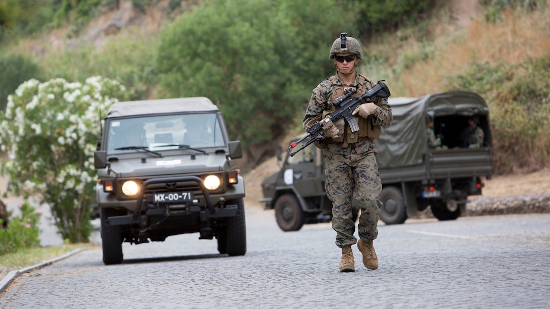 U.S. Marine Corps Lance Cpl. Dakota Jackson, a rifleman with Special Purpose Marine Air-Ground Task Force-Crisis Response-Africa, guides a vehicle to the evacuation collection point during Exercise Orion 16 in Santa Margarida, Portugal, June 23, 2016. The Marines were tasked as the quick response force during the exercise, supporting Portuguese soldiers during non-combatant evacuation operations. 