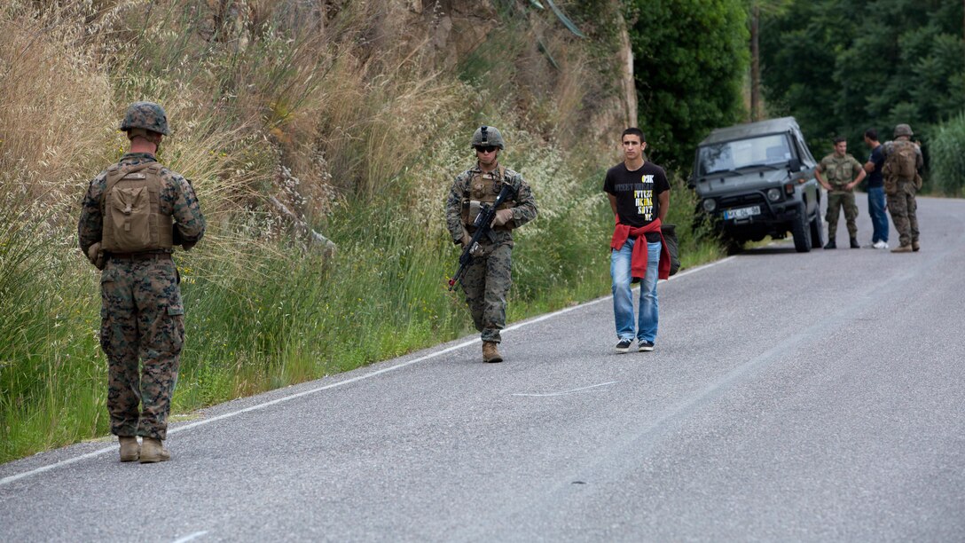 U.S. Marines with Special Purpose Marine Air-Ground Task Force-Crisis Response-Africa escort a simulated refugee to an evacuation collection point during Exercise Orion 16 in Santa Margarida, Portugal, June 23, 2016. The Marines were tasked as the quick response force during the exercise, supporting Portuguese soldiers during non-combatant evacuation operations. 