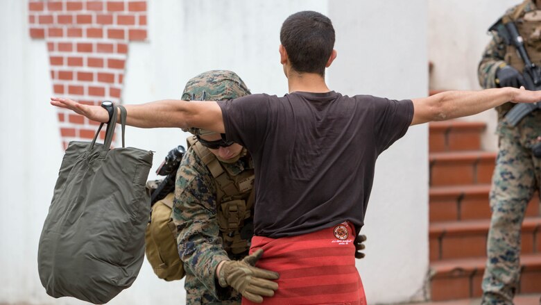 U.S. Navy Hospitalman Austin Boles, a corpsman with Special Purpose Marine Air-Ground Task Force-Crisis Response-Africa searches a simulated refugee for hidden weapons during Exercise Orion 16 in Santa Margarida, Portugal, June 23, 2016. Exercise Orion is an annual crisis response operation hosted by the Portuguese military, bringing together forces from Portugal, Spain and the U.S. to enhance interoperability among NATO forces. 