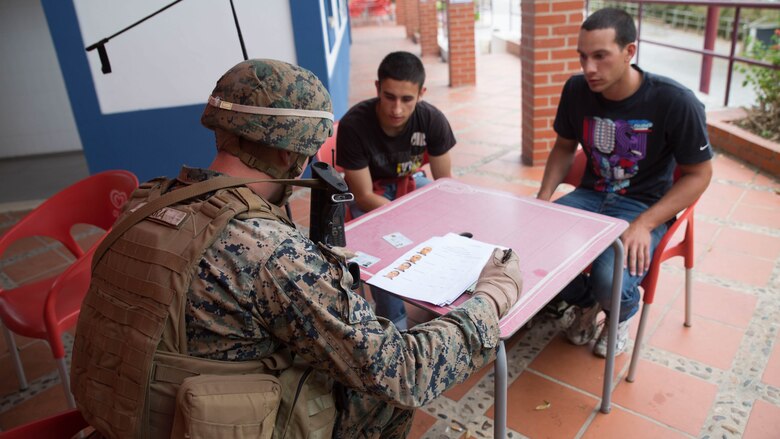 U.S. Marine Corps Sgt. John Mara, a squad leader with Special Purpose Marine Air-Ground Task Force-Crisis Response-Africa, verifies the identities of two simulated refugees during Exercise Orion 16 in Santa Margarida, Portugal, June 23, 2016. This training gave the Marines an opportunity to work side by side the Portuguese military, providing invaluable experience for future joint operations.