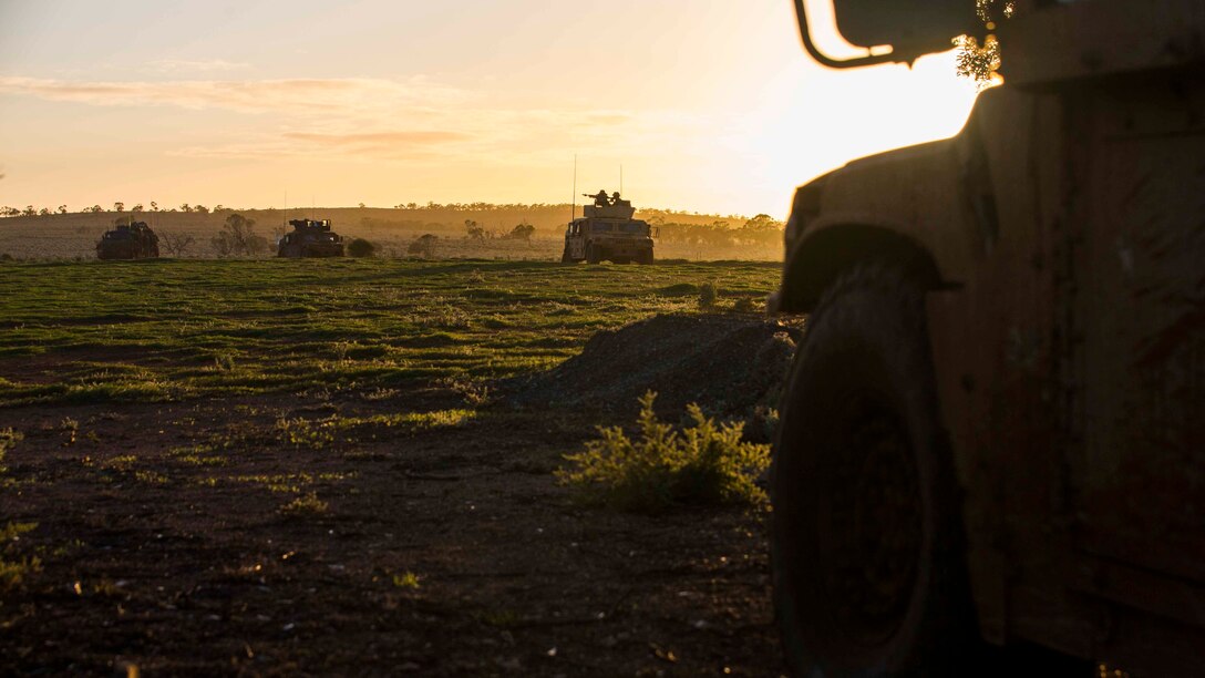 U.S. Marines with Weapons Company, 1st Battalion, 1st Marine Regiment meet at an objective point to provide security at Cultana Training Area, South Australia, Australia, July 1, 2016. The Marines moved to their first objective point during Exercise Hamel, a trilateral training exercise with Australian, New Zealand, and U.S. forces to enhance cooperation, trust, and friendship.