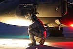 A U.S. Army UH-60 Black Hawk helicopter crew member assigned to the Puerto Rico Army National Guard inspects the aircraft prior to conducting night flight training at the aviation support facility in Isla Grande, Puerto Rico, Sept. 2, 2014. (U.S. Army National Guard photo by Sgt. Pablo Pantoja/Released)