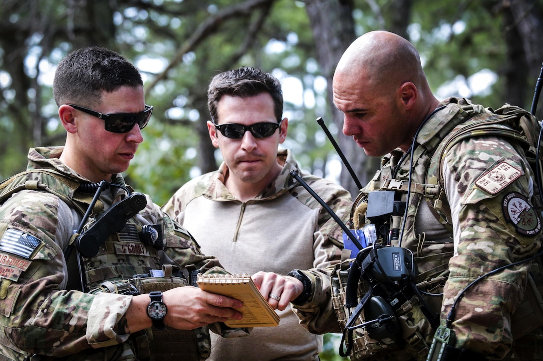 Airmen go over plans while supporting soldiers during Exercise Gridiron at Joint Base McGuire-Dix-Lakehurst, N.J., June 27, 2016. The airmen are assigned to the New Jersey Air National Guard's 227th Air Support Operations Squadron. The soldiers are reservists assigned to the 404th Civil Affairs Battalion. Air National Guard photo by Tech. Sgt. Matt Hecht