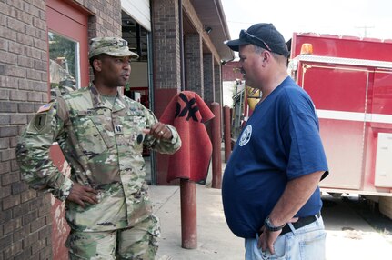 Capt. Will Hargis of the West Virginia Army National Guard’s CERF-P team and Kevin Clendenin, fire chief for the town of Clendenin, W. Va., discuss the details of WVARNG and other first responders’ efforts in saving lives the night of June 23. Sudden, severe flooding threatened the lives of people in the area of Clendenin. The WVARNG worked hand-in-hand with other civilian first responders to quickly react and save lives.