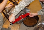 In order to assess the acceptability of the new torque converter as an alternate item for the present one a fit check was needed to insure compatibility with the Humvee engine and transmission. Sgt. 1st Class Joshua Brown with the Ohio Army National Guard conducts a transportation bracket fit test showing the seated torque converter has the same axial relationship with the transmission flange as the current item.