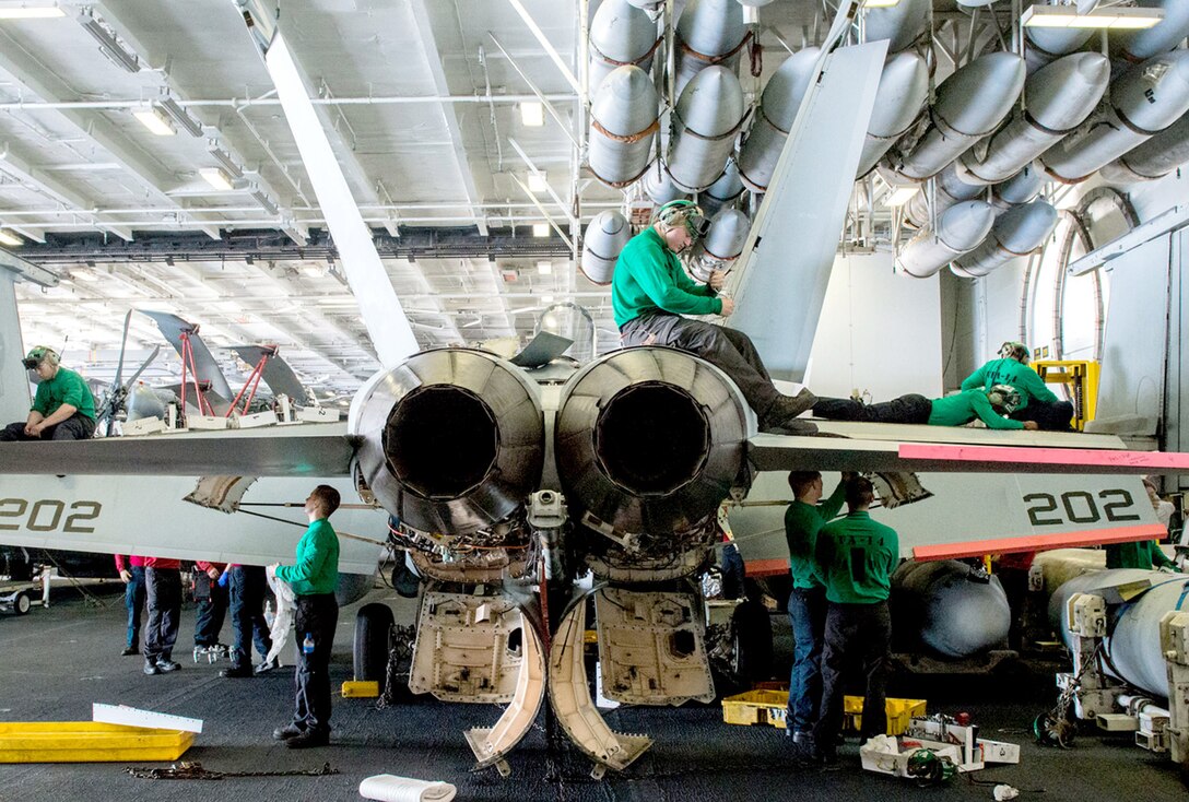 160122-N-MY174-015 PACIFIC OCEAN (Jan. 22, 2016) - Sailors perform maintenance on an F/A-18E Super Hornet from the Top Hatters of Strike Fighter Squadron (VFA) 14 USS John C. Stennis' (CVN 74) hangar bay. Providing a combat-ready force to protect collective maritime interests, Stennis is operating as part of the Great Green Fleet in the U.S. 3rd Fleet area of operations on a regularly scheduled Western Pacific deployment. (U.S. Navy photo by Mass Communication Specialist Seaman Tomas Compian / Released)