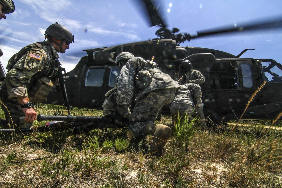 Soldiers transport simulated casualties to a UH-60 Black Hawk helicopter during Exercise Gridiron at Joint Base McGuire-Dix-Lakehurst, N.J., June 27, 2016. Air National Guard photo by Tech. Sgt. Matt Hecht