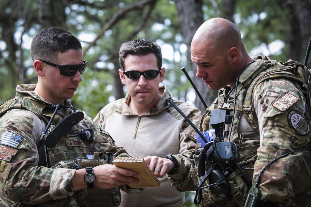 U.S. Air Force Tactical Air Control Party Airmen from the New Jersey Air National Guard's 227th Air Support Operations Squadron go over plans while supporting the U.S. Army Reserve's 404th Civil Affairs Battalion during Exercise Gridiron at Joint Base McGuire-Dix-Lakehurst, N.J., June 27, 2016. (U.S. Air National Guard photo by Tech. Sgt. Matt Hecht/Released)