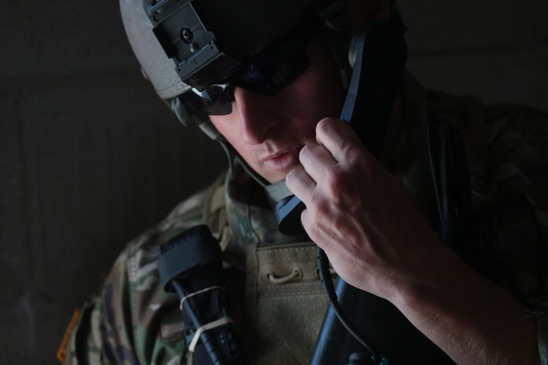 A U.S. Army Reserve Soldier from the 404th Civil Affairs Battalion communicates with higher headquarters while under fire during Exercise Gridiron at Joint Base McGuire-Dix-Lakehurst, N.J., June 27, 2016. (U.S. Air National Guard photo by Tech. Sgt. Matt Hecht/Released)