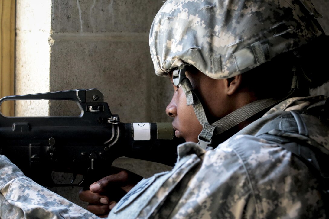 A U.S. Army Reserve Soldier from the 404th Civil Affairs Battalion provides cover for a besieged police station during Exercise Gridiron at Joint Base McGuire-Dix-Lakehurst, N.J., June 27, 2016. (U.S. Air National Guard photo by Tech. Sgt. Matt Hecht/Released)