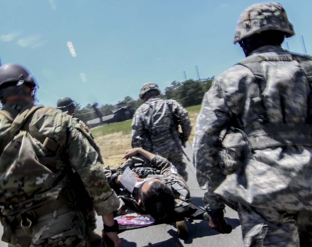 U.S. Army Reserve Soldiers from the 404th Civil Affairs Battalion transport simulated casualties to a New Jersey Army National Guard UH-60 Black Hawk helicopter during Exercise Gridiron at Joint Base McGuire-Dix-Lakehurst, N.J., June 27, 2016. (U.S. Air National Guard photo by Tech. Sgt. Matt Hecht/Released)